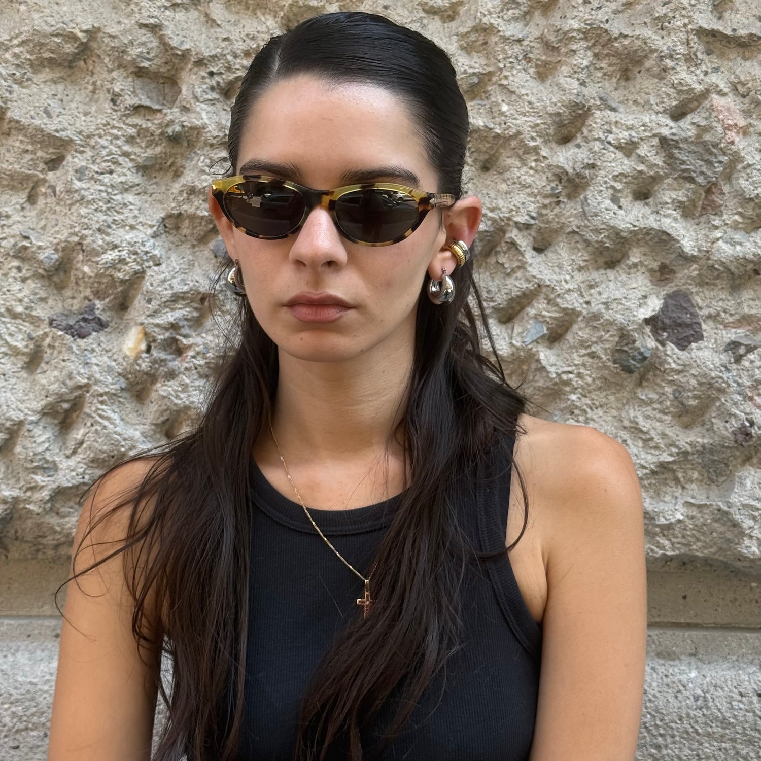 Front view of Prada tortoiseshell cat-eye sunglasses with glossy acetate frame and dark tinted lenses.
