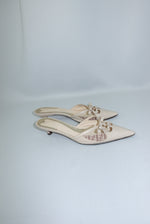 Vintage Fendi beige mules side view showing sleek profile and kitten heel