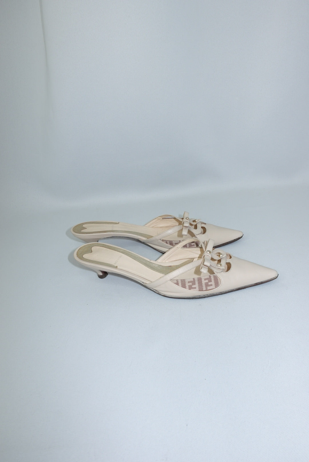 Vintage Fendi beige mules side view showing sleek profile and kitten heel