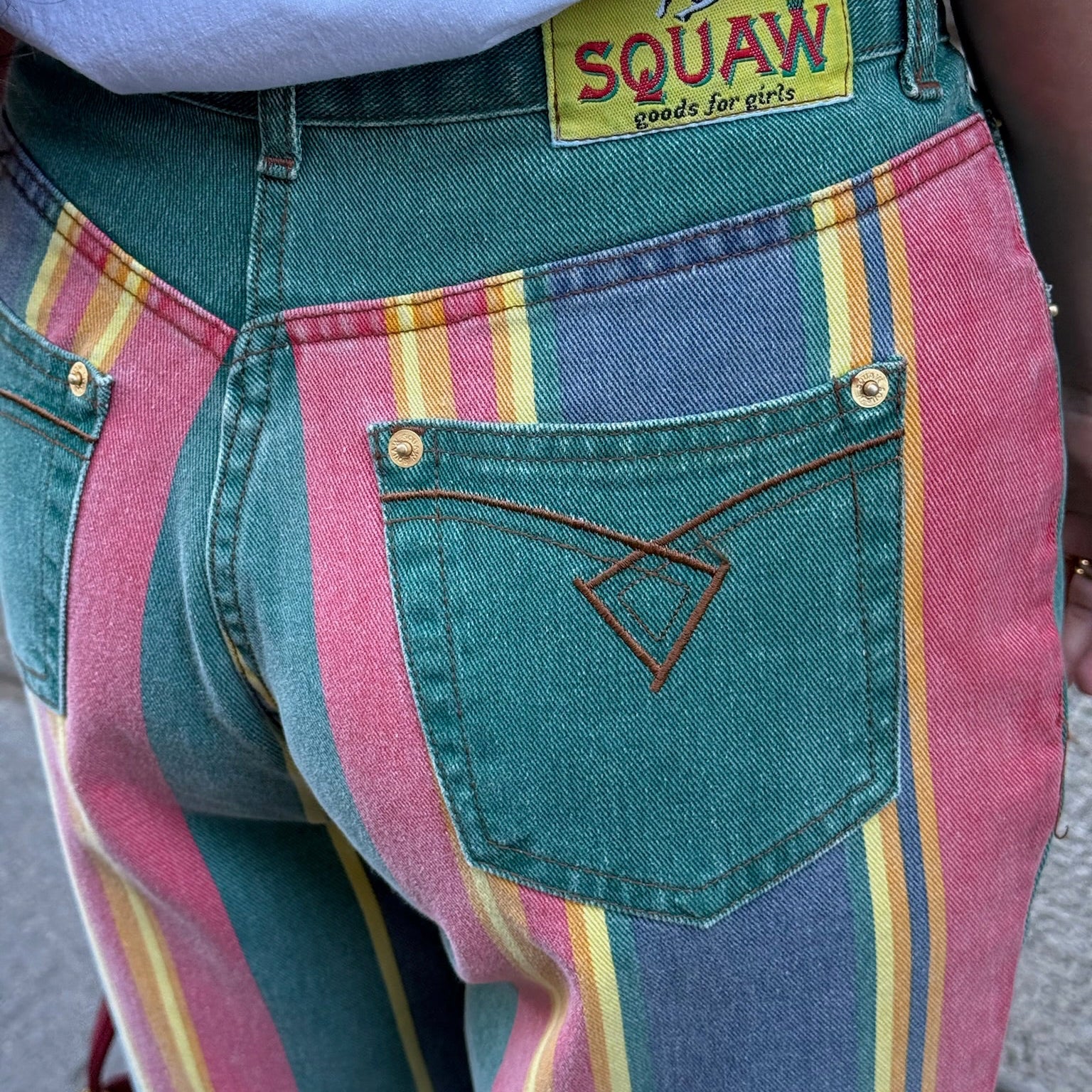 Close-up detail of the multicolor rainbow striped panel and vintage denim construction on the back of the mom jeans.