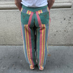 Front view of vintage green rainbow print straight jeans featuring a high-rise waist, straight-leg fit and classic five-pocket design.