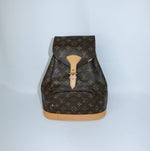 Vintage Louis Vuitton Monogram canvas backpack front still life view with signature leather details