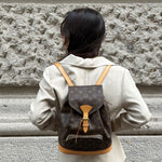 Vintage Louis Vuitton Monogram backpack worn close-up showing iconic canvas and leather detailing