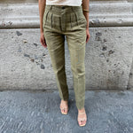 Front view of vintage olive green high-waisted tailored pants with front pleats and straight-leg silhouette.
