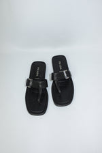 Vintage Prada black leather sandals front view featuring statement silver-toned buckle detail