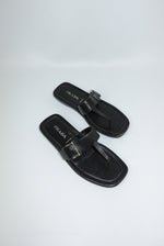 Vintage Prada black leather sandals side view showing sleek silhouette and silver buckle