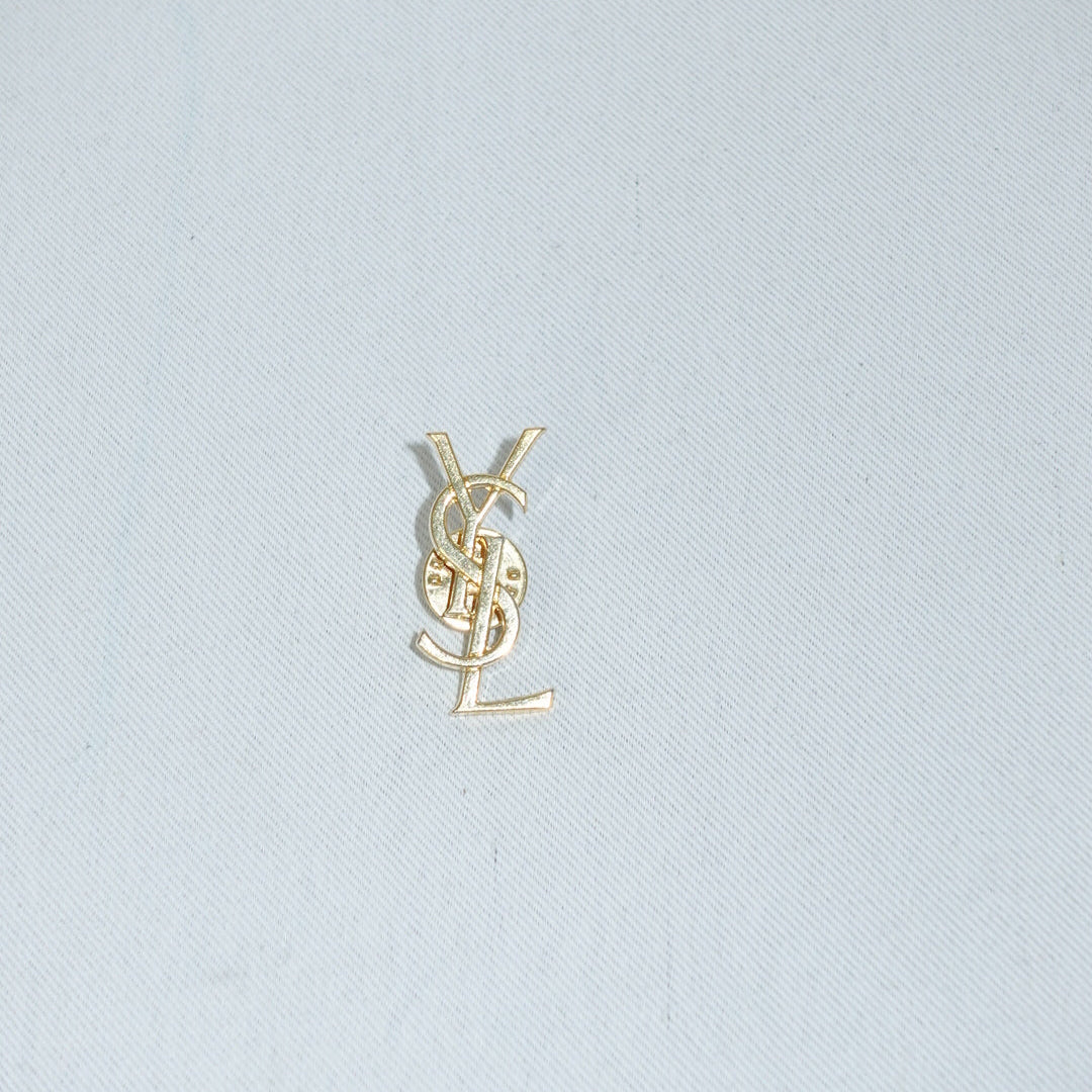 YSL vintage gold logo brooch front view