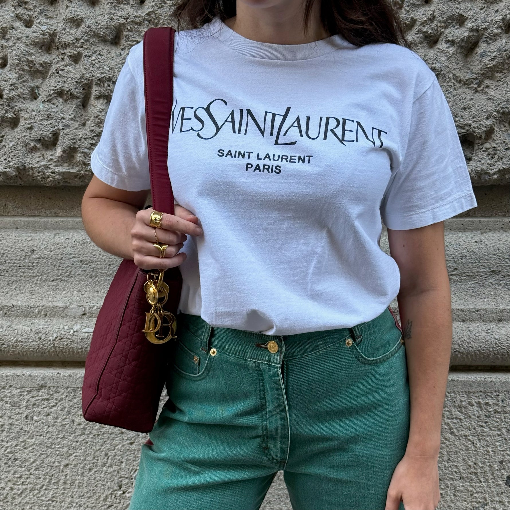Model wearing a Yves Saint Laurent white logo T-shirt styled with a relaxed fit, showcasing its timeless luxury and minimalist aesthetic.